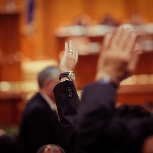 Raised hands in courtroom